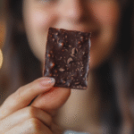 The Pink Salt Trick Recipe That’s Gaining Popularity for a Reason 9 Woman holding dark chocolate pink salt bark